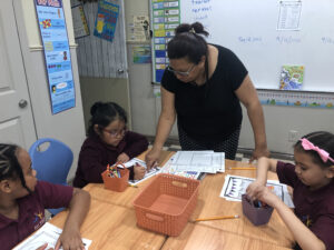 2nd grade teacher working with students in reading.